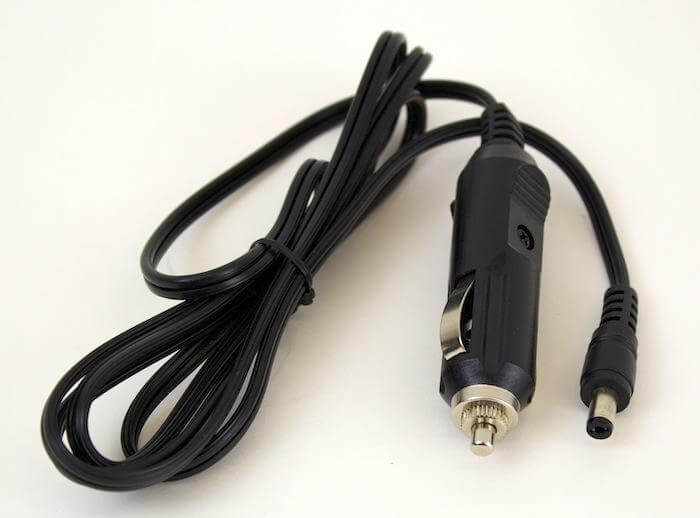 The Naxa 12 Volt DC Cord, featuring a universal connector and designed for powering TVs via a car cigarette lighter socket, is neatly coiled on a white background—perfect for RV TV power needs.