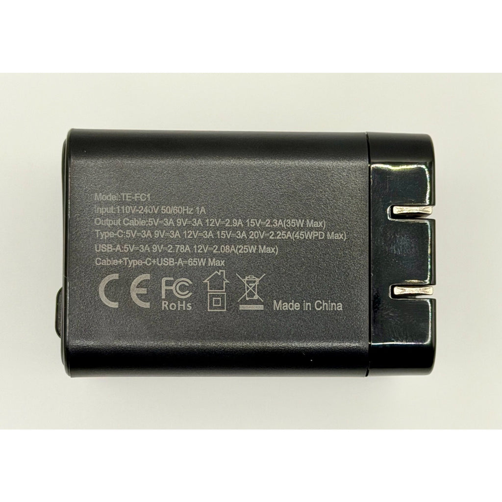 The 65W GaN USB-C Wall Charger with Built-In Cable & Foldable Plug is black, features fast USB-C and USB ports, labeled technical specs and safety certifications, and displays "Made in China" in white text.