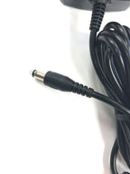 A close-up of the Naxa AC Adapter Power Supply Charger (12V, 3A, 36W, 2.1mm x 5.5mm) for LED LCD TVs up to 15", featuring a black coiled cable with barrel plug connector on a white surface.