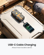 A 50000mAh Solar Power Bank – Magnetic Wireless Charger with Hand Crank, 4 Solar Panels & Built-In Charging Cables charges an iPhone 17 outdoors via USB-C cable, reaching 60% in just 30 minutes. The emergency power bank also features convenient magnetic wireless charging.