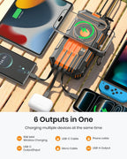 The 50000mAh Solar Power Bank – Magnetic Wireless Charger with Hand Crank, 4 Solar Panels & Built-In Charging Cables powers your smartwatch, phone, tablet, wireless earbuds, and game console simultaneously with multiple outputs—including USB-C, USB-A, and magnetic wireless charging—shown on a wooden surface. Perfect as an emergency power bank or solar charger for all your devices.