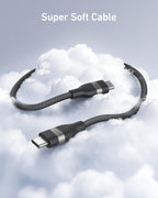 A black Anker USB-C to USB-C Cable (3 ft/6 ft, 240W, Upcycled-Braided) floats on clouds with "Super Soft Cable" above, emphasizing its softness, flexibility, and ultra-durable upcycled braided design.