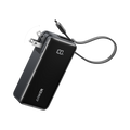 A black Anker Power Bank (10K, Fusion, Built-In Cable) with a digital display reading "100%" and a foldable wall plug. Its charging cable extends outward, all set against a plain white background.