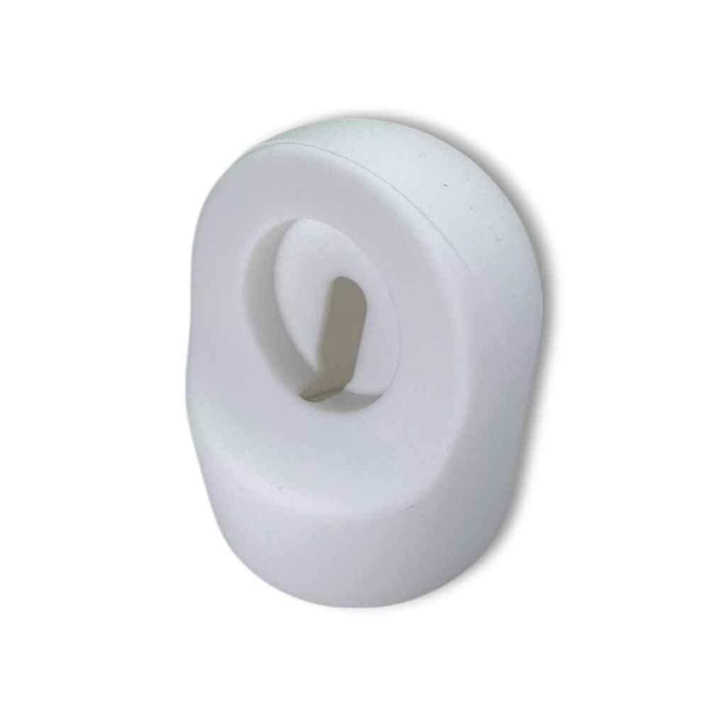 The Charging Stand is a white, oval-shaped plastic wall hook with a central slot and protruding hook—practical and modern, ideal for organizing spaces or travel, just like a portable Apple Watch charging stand.