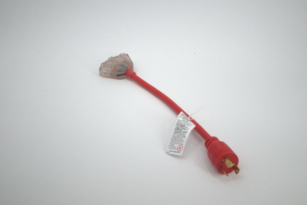 A 30 Amp Generator Adapter Cord (L5-30P to 3x 5-15R outlets) with three clear outlets, a red extension cord, a three-prong plug on one end, and a white warning label is shown lying on a white surface.