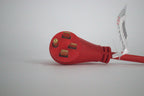 A close-up of a red 50 Amp Generator Adapter Cord 14-50P to 3x 5-15R Outlets with four brass prongs on a white surface. A tag with text is attached to the heavy-duty cord near the plug.