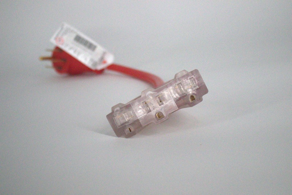 A close-up of the 50 Amp Generator Adapter Cord 14-50P to 3x 5-15R Outlets, featuring clear three-outlet connectors and a red heavy-duty cord. The adapter and plug are visible but out of focus in the background.