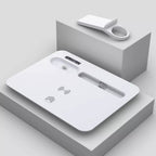 White electronic device with wireless charging pad on a gray geometric background