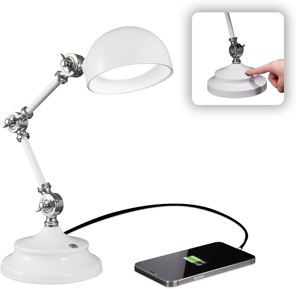 The Adjustable LED Study Lamp with Luminaire EyeCare USB Charging features white metal accents and delivers natural daylight illumination. A smartphone charges via a black cable connected to the lamp’s base, emphasizing its multifunctional design. An inset image shows a finger touching a button on the base, suggesting intuitive EyeCare lighting touch controls.