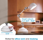 An Adjustable LED Study Lamp with Luminaire EyeCare USB Charging is placed on a desk beside a laptop. Text emphasizes its height adjustment range from 6.5 to 15.5 inches and its stable 6.12-inch base. A finger pressing the base showcases how easily the height can be adjusted, while the lamp’s eye-care lighting provides natural daylight illumination—ideal for comfortable studying or working sessions.