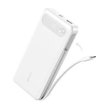 The Anker Power Bank (20K, 87W, Built-In USB-C Cable) is shown in white with its built-in USB-C cable partially pulled out, a digital display, and two USB ports on top. This 20,000mAh laptop power bank features 65W fast charging and is set against a plain light background.