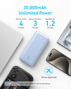 A blue Anker Power Bank (20K, 87W, Built-In USB-C Cable) rests on a desk with text: "20,000mAh Unlimited Power," emphasizing its remarkable charging capacity—enough for iPhone 15 Pro (4 charges), Galaxy S24 Ultra (3 charges), MacBook Air (1.2 charges)—plus an airline-approved icon. With a built-in USB-C cable and powerful 65W fast charging, this 20,000mAh laptop power bank is the perfect companion to keep all your devices powered wherever you go.