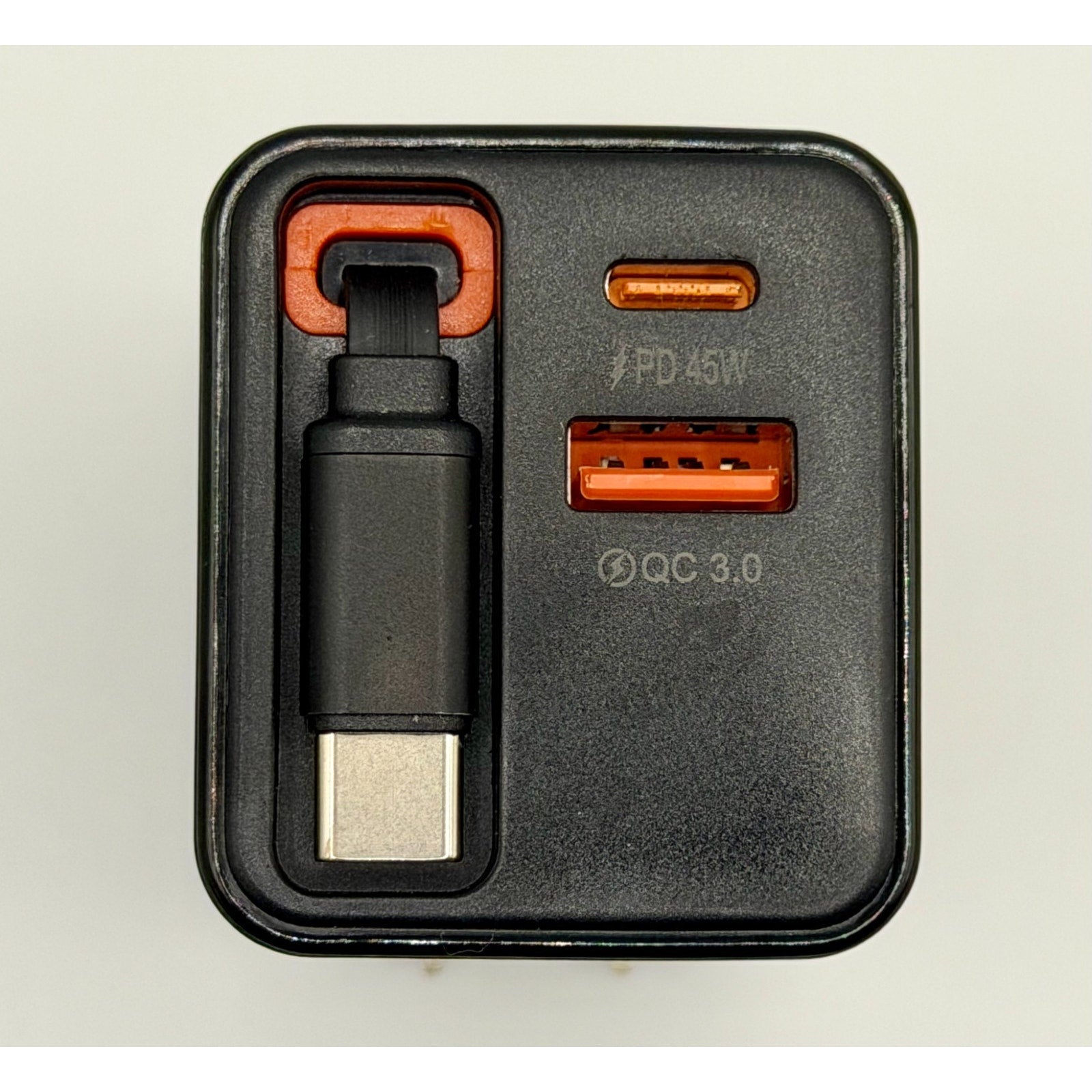 A close-up of the 65W GaN USB-C Charger PD Fast Charge with a foldable plug, built-in cable, and three ports: retractable USB-C, USB-C labeled "PD 45W," and an orange USB-A marked "QC 3.0." Brand new.