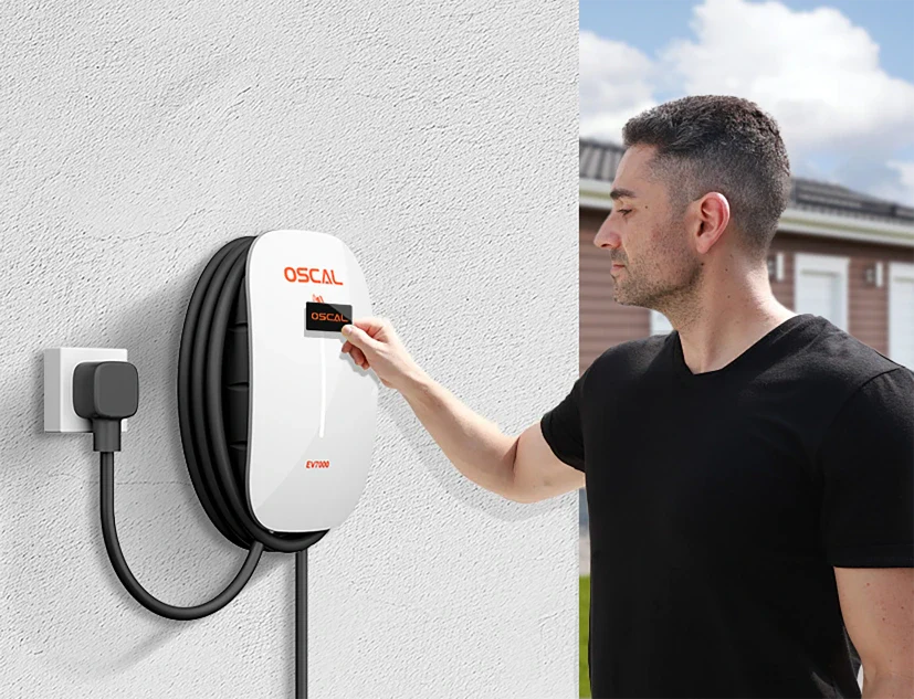 A man in a black shirt uses the EV Charger 7kw, its cable coiled neatly. This smart wall-mounted Level 2 charger, plugged into an outdoor socket, provides convenient home charging outside the house.