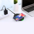 The Esoulk QI Certified 10W Wireless Charging Fast Charger Pad is wirelessly charging a smartphone next to a laptop and power adapter on a white desk—ideal for exploring new workspace organization styles.